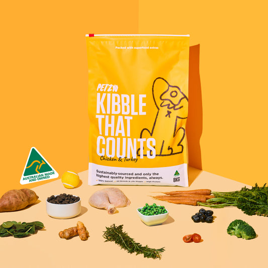 A bag of Kibble That Counts (Chicken & Turkey Flavor) with its ingredients displayed in front of it.