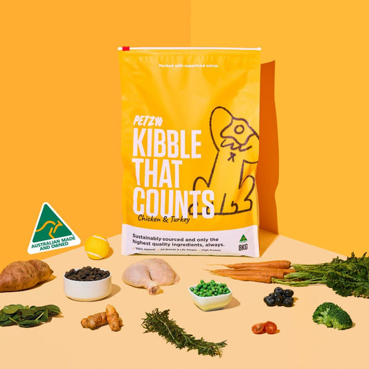 A bag of Kibble That Counts (Chicken & Turkey Flavor) with its ingredients displayed in front of it.