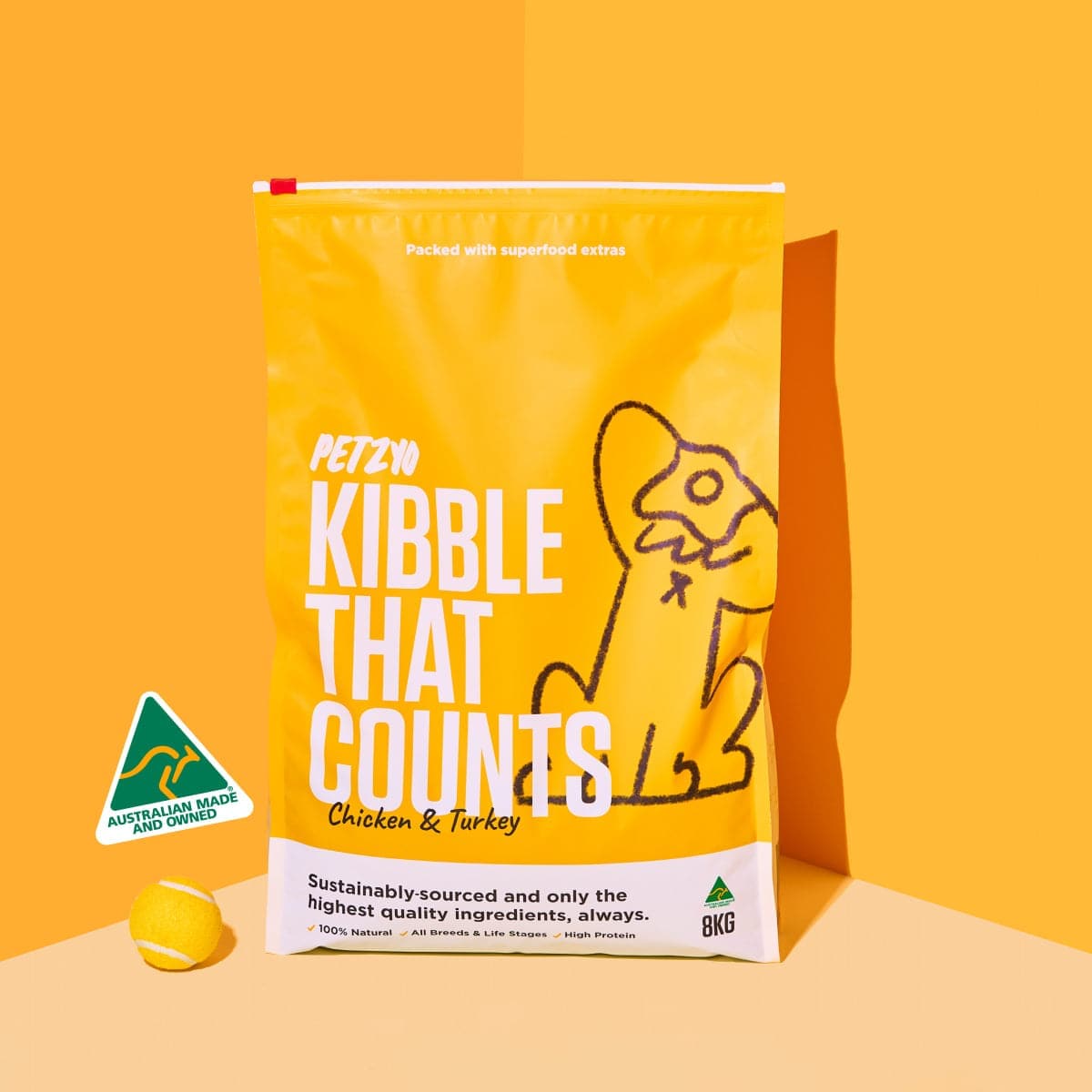A bag of Kibble That Counts (Chicken & Turkey Flavor) with tennis ball on the side.